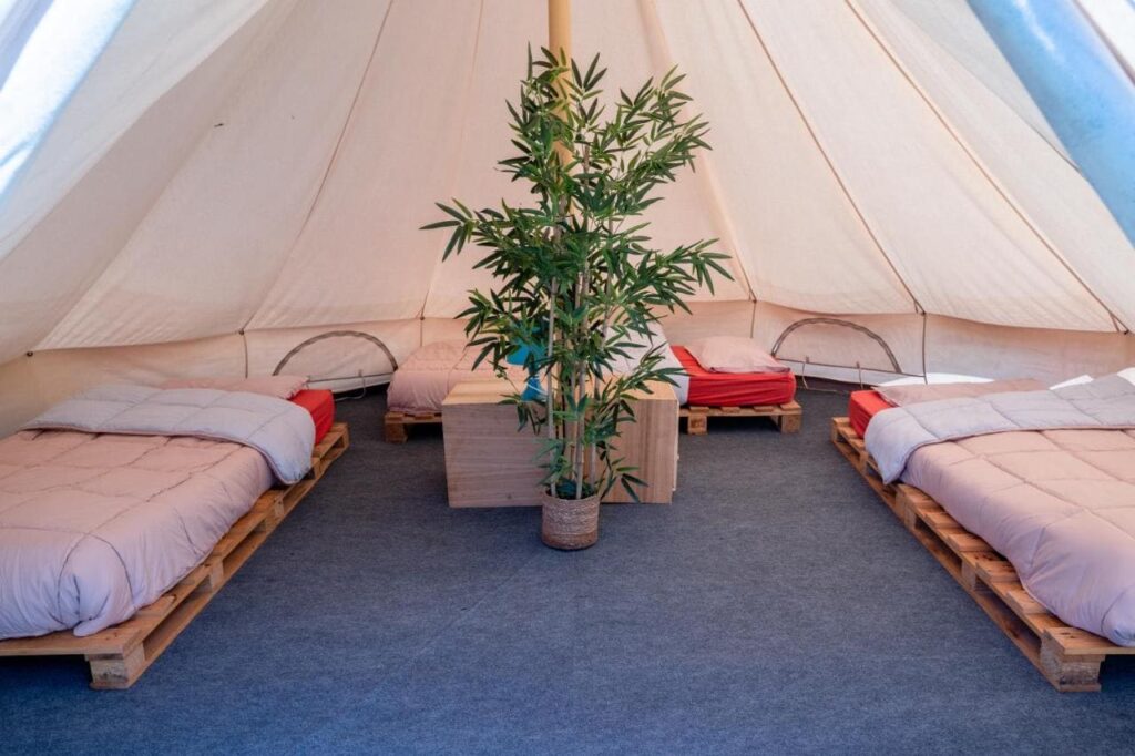 camas individuales en el tipi glamping oyambre surf camp